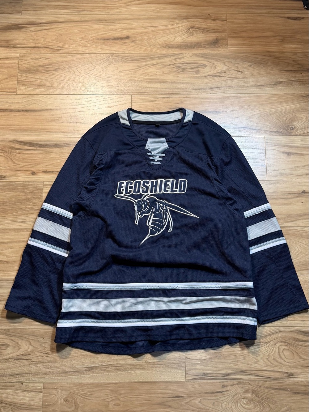 Navy blue hockey jersey with white stripes on sleeves and hem